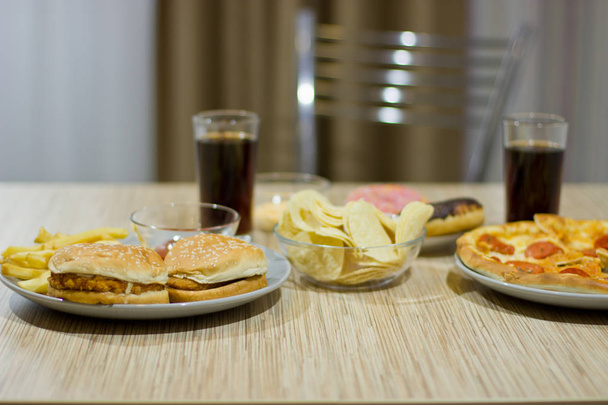 Unhealthy concept. unhealthy food: Burger, sauce, potatoes, pizz - Photo, Image