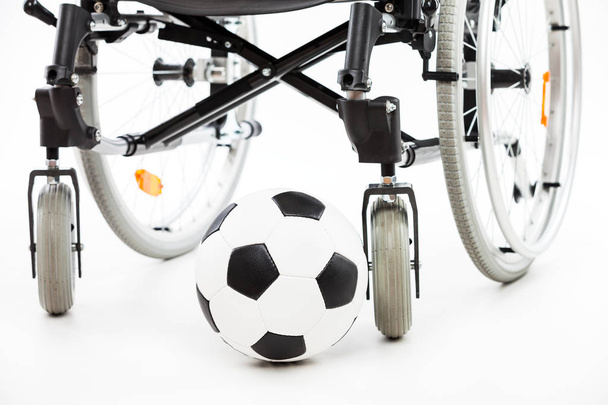 Wheelchair for invalid or disabled person and soccer ball - Foto, Imagen