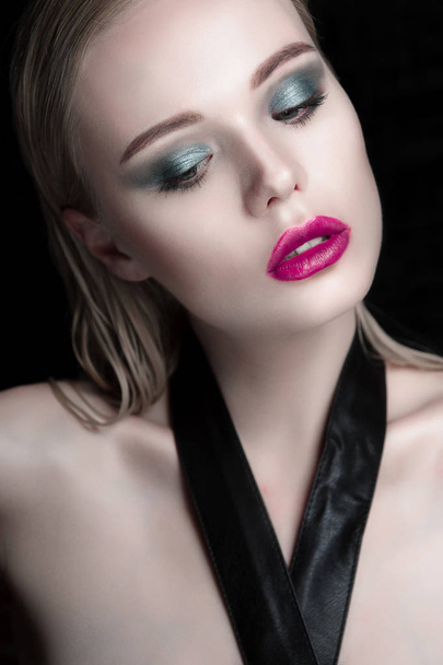 Portrait of beautiful girl model with pink lips and blue eyes with leather belt on her neck, fresh clean highlighted skin. Fashion retouched close up shot. - Фото, изображение
