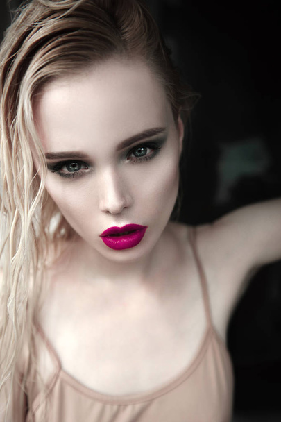 Portrait of beautiful girl model with pink lips and blue eyes with leather belt on her neck, fresh clean highlighted skin. Fashion retouched close up shot. Sad depressed mood - Фото, изображение