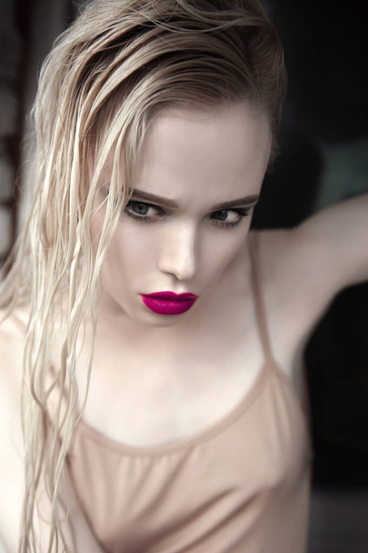 Portrait of beautiful girl model with pink lips and blue eyes with leather belt on her neck, fresh clean highlighted skin. Fashion retouched close up shot. Sad depressed mood - Foto, Imagem
