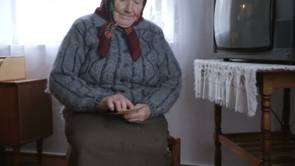Poor grandmother looks old photos. Memoirs - Footage, Video