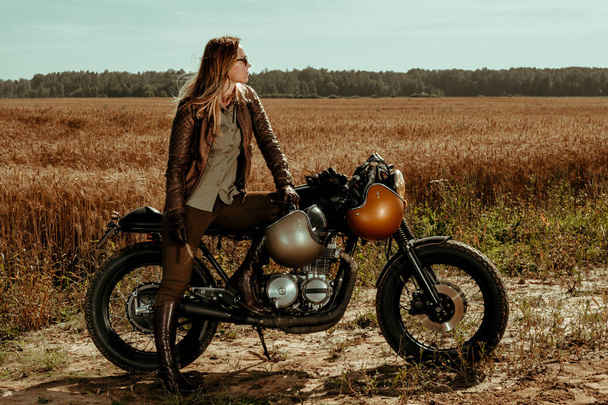 Woman rider with his vintage custom made cafe racer - Photo, Image