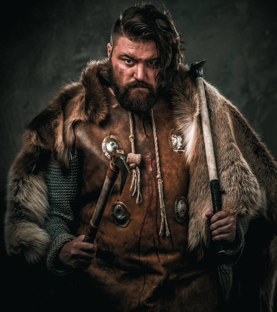 Viking with cold weapon in a traditional warrior clothes - 写真・画像