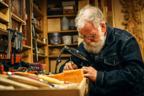 starszy specjalista rzeźbiarstwa drewna podczas pracy - Zdjęcie, obraz