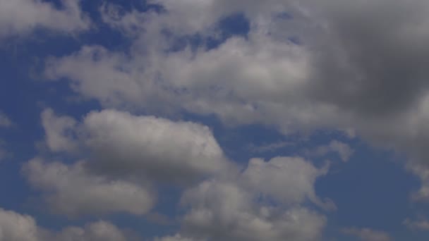 White puffy clouds move across a brilliant blue sky - Footage, Video