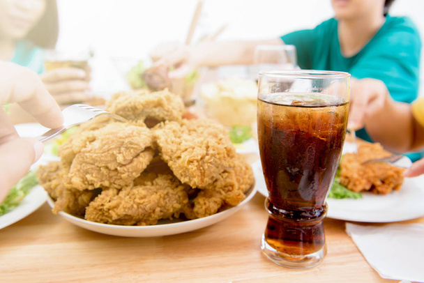 Pollo frito y refresco en la mesa de comedor
 - Foto, Imagen