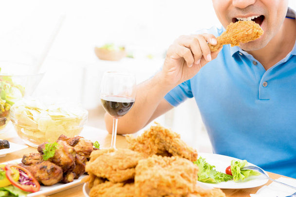 Young man eating fried chicken - Photo, Image