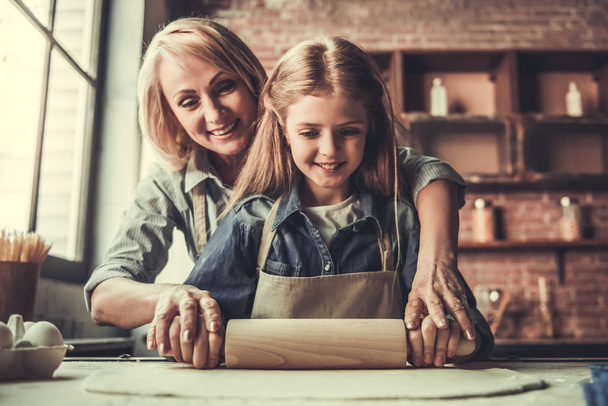 Grandma and granddaughter in kitchen - Photo, Image