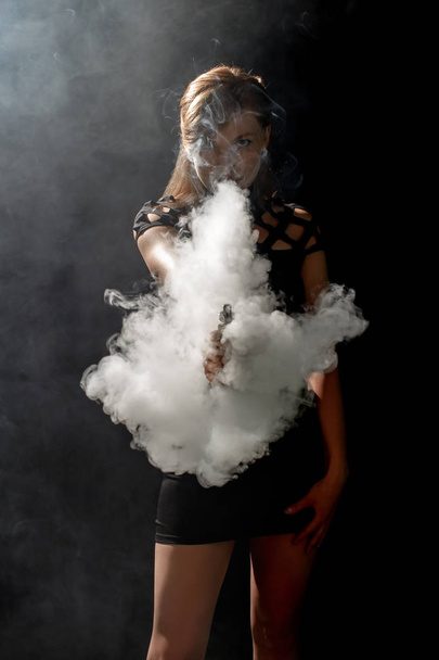Beautiful girl vaping from e-cigarett - Photo, image