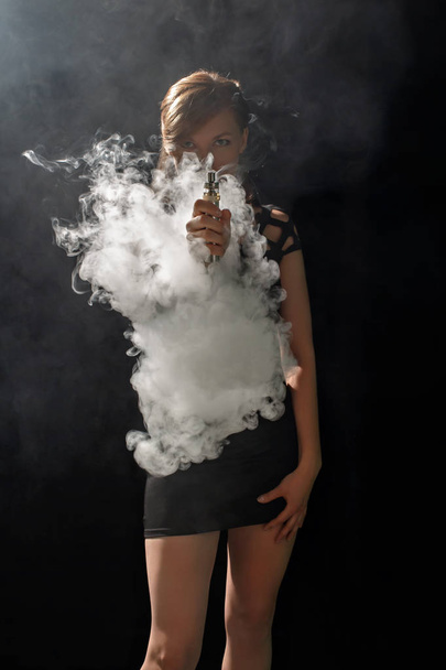 Beautiful girl vaping from e-cigarett - Zdjęcie, obraz