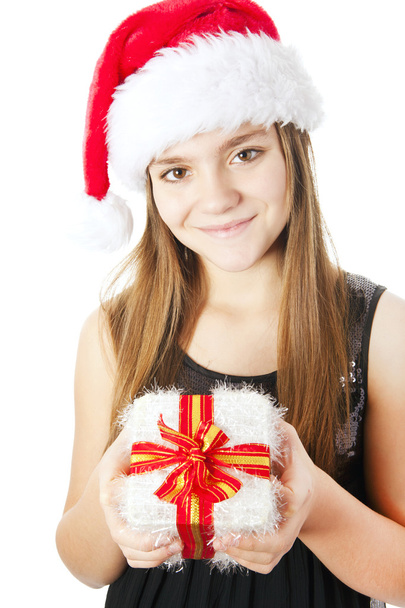 Christmas girl holding present isolated over white - Foto, imagen