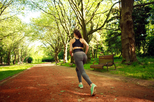 Young woman exercising running in summer park - Valokuva, kuva