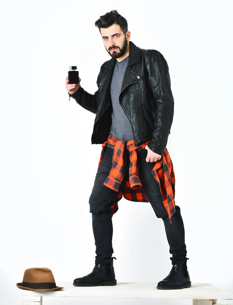 Bearded man, caucasian hipster with moustache holding perfume bottle - Photo, Image