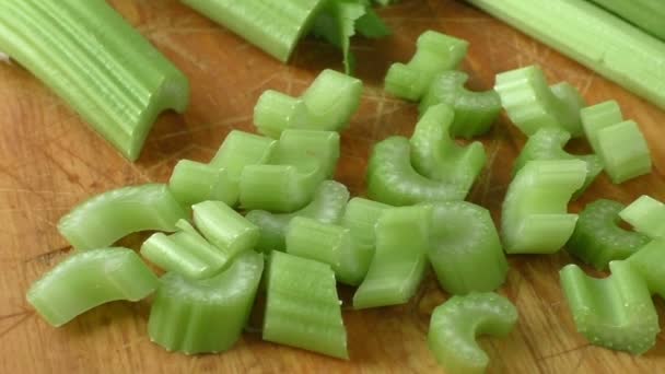 Celery chopped on wooden cutting board - Footage, Video