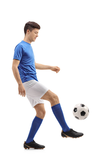 Teenage soccer player juggling a football - Photo, Image