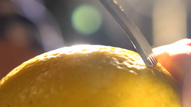 slow motion citrus zester on lemon skin, twirls of zest falling against. macro - Footage, Video
