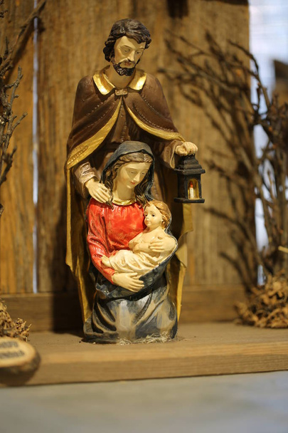 nativity set with the Holy Family and Saint joseph who holds a l - Photo, Image