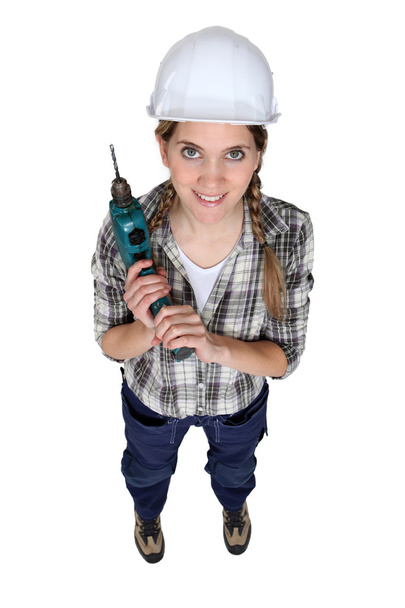 Craftswoman holding a drill - Foto, Imagen