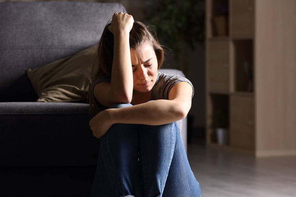 Sad teen at home in a dark living room - Foto, immagini