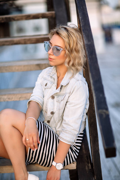 portrait of a young woman, blonde, glasses, outdoors in the park - Photo, Image