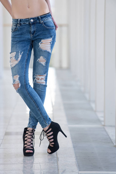 jeans on legs of young woman, girl in fashionable shoes - Foto, Imagen