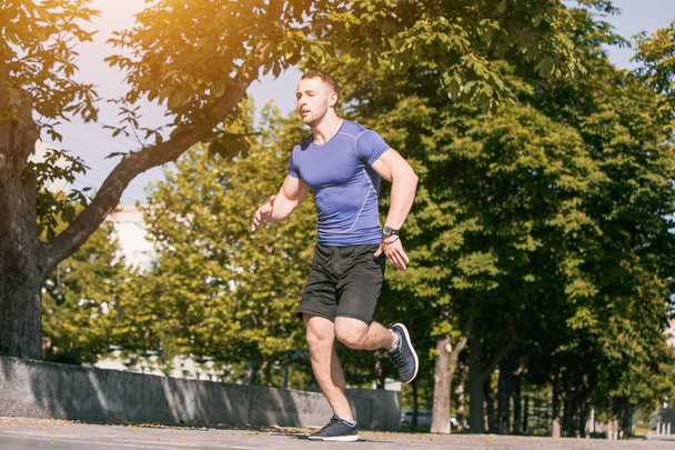 Man running in park at morning. Healthy lifestyle concept - Fotoğraf, Görsel