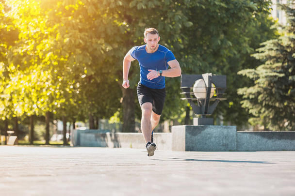 Man running in park at morning. Healthy lifestyle concept - Photo, image