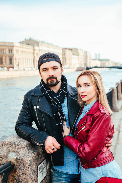 Stylish couple in city . Beautiful couple in love hugging and kissing on street - Фото, изображение
