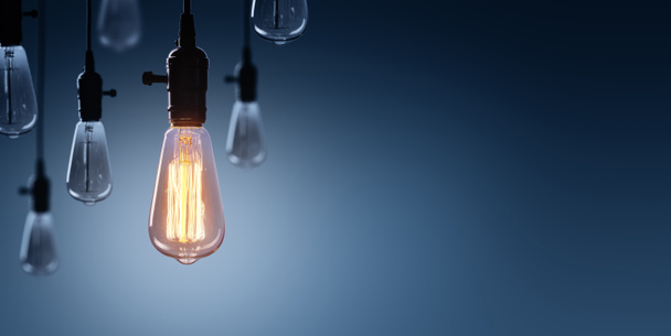 Innovation And Leadership Concept - Glowing Bulb On Among Bulbs Off - Photo, Image