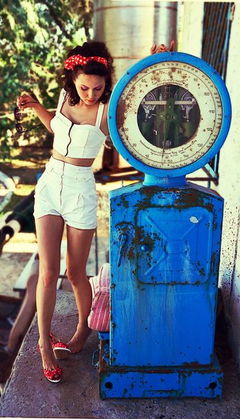Beauty and health .. The girl is standing on the scales. Girl in white overalls. Vintage, retro. Pin up          Beauty and health - Fotoğraf, Görsel