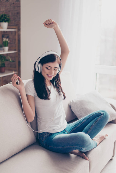Move your body! Dreamy charming brunette is listening to music i - 写真・画像