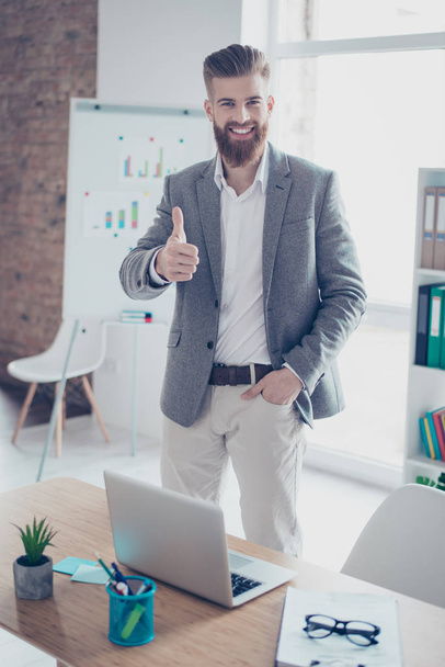 Successful young man is showing thumb up in office. He is glad t - Fotoğraf, Görsel