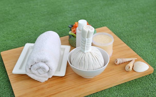 Spa herbal compressing ball with towels and Salt Scrub, Spa concept background - Фото, зображення