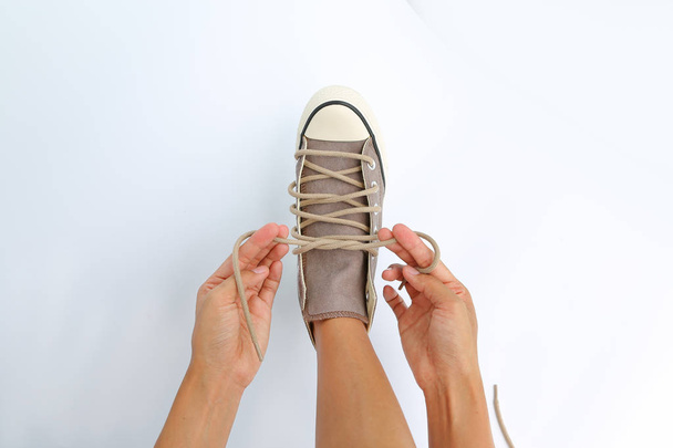 Close up tie her shoes canvas Sneakers on white background - Foto, imagen