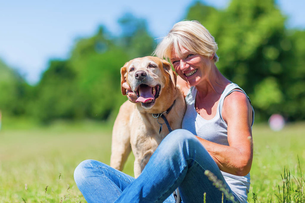 mature woman with a dog outdoor - Foto, imagen