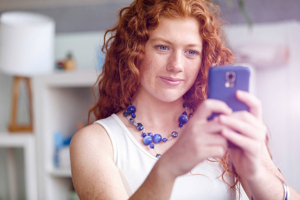 Happy beautiful young businesswoman using smart phone smiling - Fotografie, Obrázek