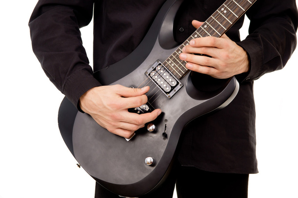 Beautiful guy is playing the electric guitar, large-plan - Photo, Image