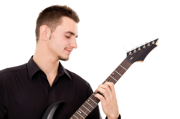 Beautiful guy, carefully plays the electric guitar - Photo, Image