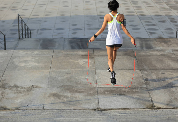 young woman jumping rope  - Фото, изображение