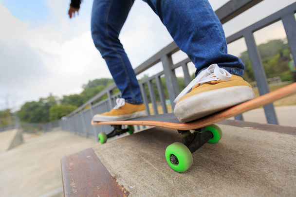 skateboarder riding at skatepark ramp - 写真・画像