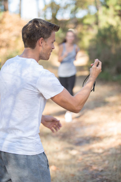 coach and jogger training in the forest - Photo, Image