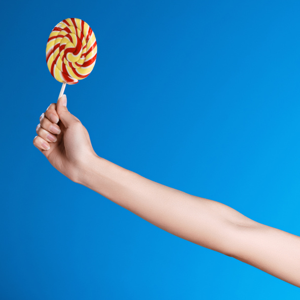 Hand holding lollipop  - Foto, Imagen
