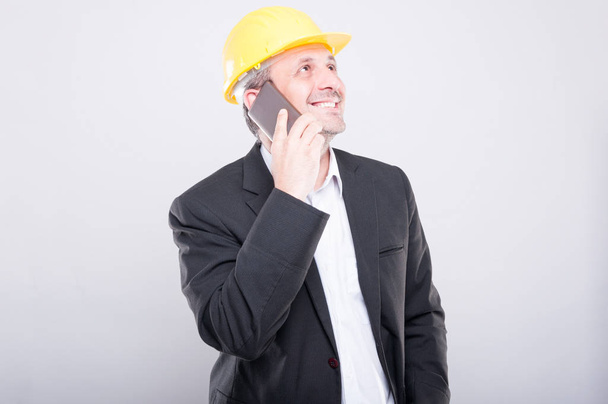 Portrait of architect smiling and talking on smartphone - Photo, Image