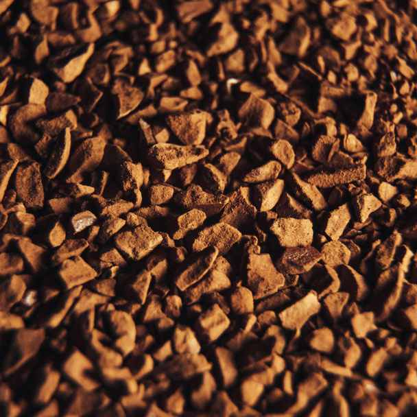 Instant coffee granules scattered brown closeup. - Фото, зображення