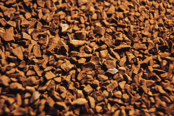 Instant coffee granules scattered brown closeup. - Foto, afbeelding