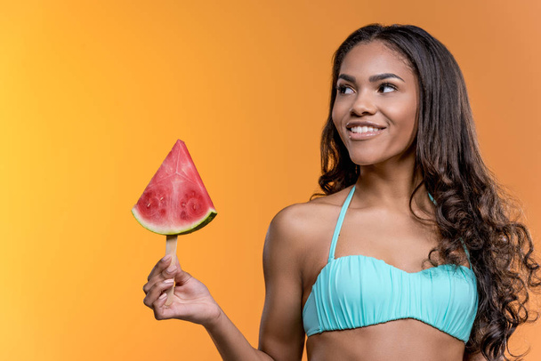woman in swimwear holding watermelon piece - Φωτογραφία, εικόνα