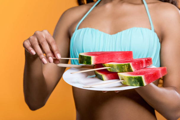 woman holding plate with watermelon slices - Fotoğraf, Görsel