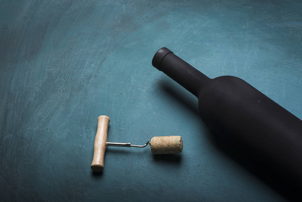 Pouring red wine into the glass against wooden background - Photo, Image