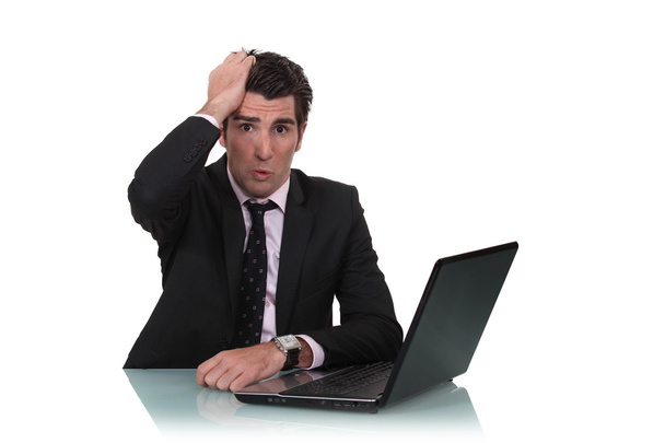 Worried businessman with a laptop - Фото, зображення